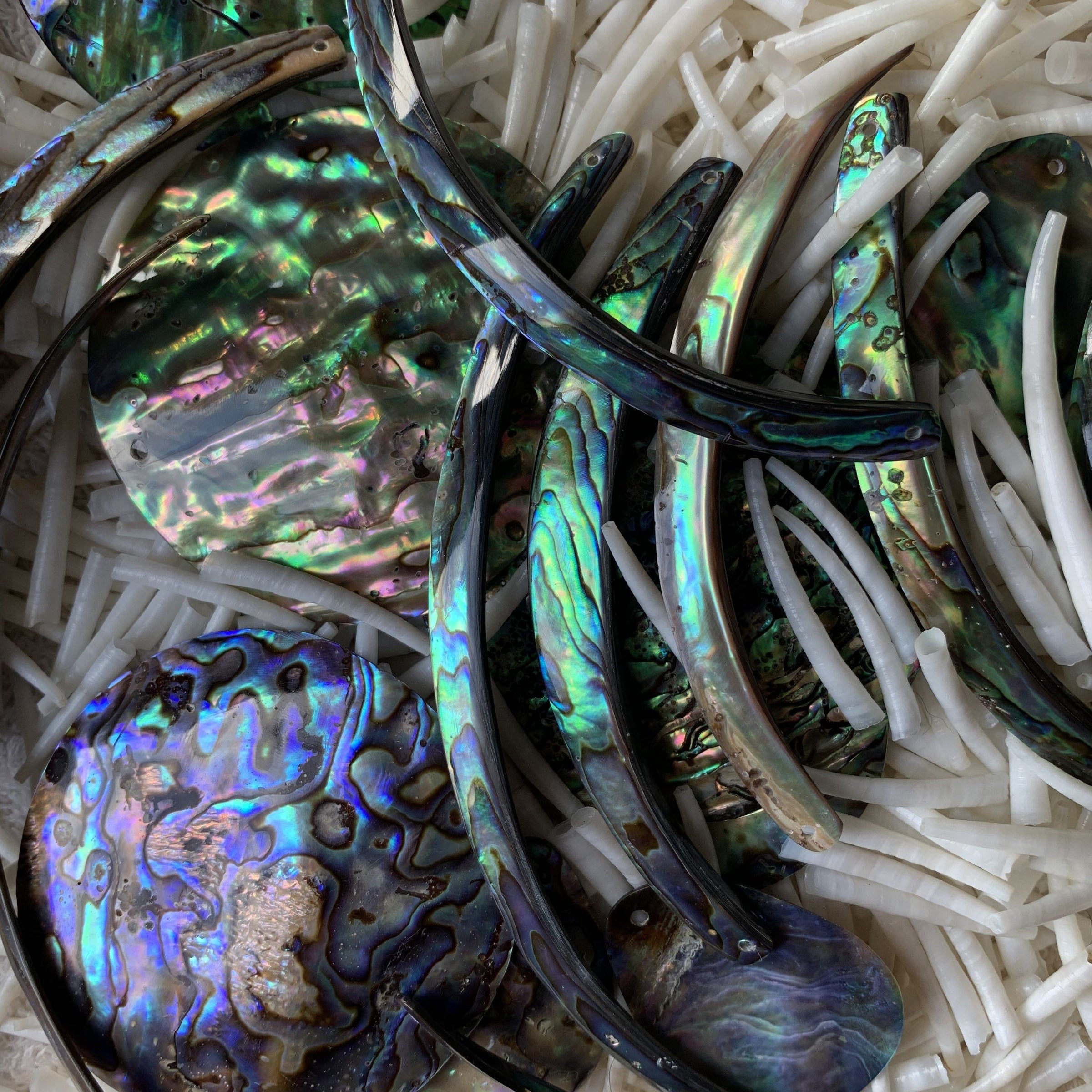 The collections has Dentalium, smooth and ridged, colorful Ribs, Rims of the abalone shells, Abalone drops and discs.